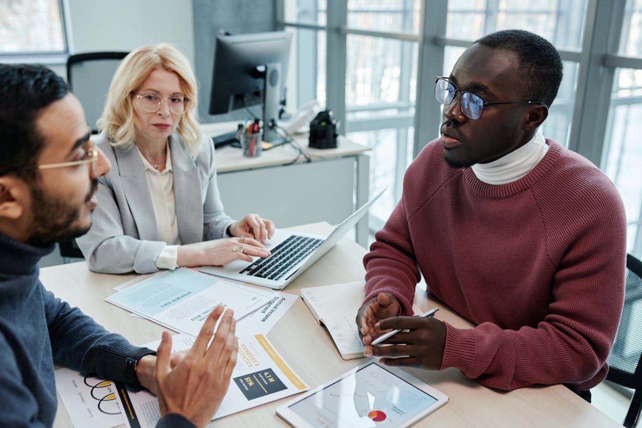 Professional team having an insightful discussion in a modern office setting.